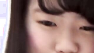 Asian cutie lifts her skirt up to show how she pees