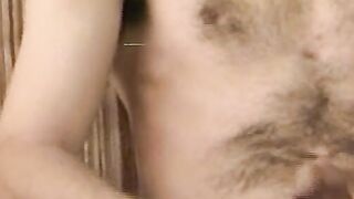 Hairy young guy tugs raging dick and cums all over the place