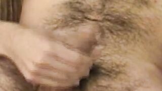 Hairy young guy tugs raging dick and cums all over the place