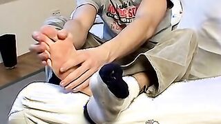 Jock sensually touches both his feet and his dick