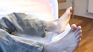 Jock sensually touches both his feet and his dick