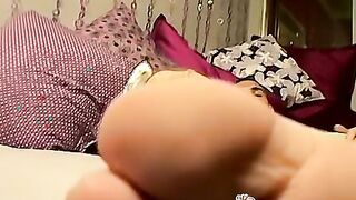 Tattooed guy massages his feet and uses socks on his cock
