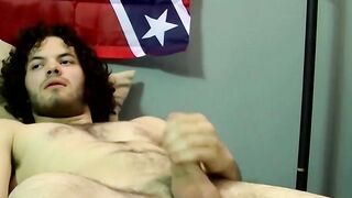 Handsome dude with curly black hair jerking off his big cock