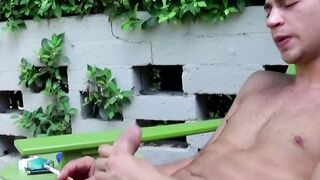 Handsome young smoker working on his huge cock outside