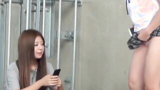 Two girls get caught pissing and filming each other outside