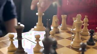 Jimena Lago and Charlie Dean sit down to a game of chess. They barely make it through two moves before
