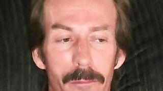 Guy with a mustache tugs his cock before cumming hard