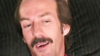 Guy with a mustache tugs his cock before cumming hard