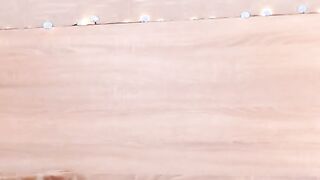 Petite Latina rides dildo in bed on webcam