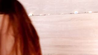 Petite Latina rides dildo in bed on webcam