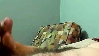 Amateur guy jerking off his juicy cock on the bedroom bed