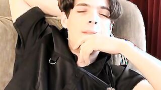 Skinny twink massages his feet and strokes massive dick