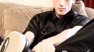 Skinny twink massages his feet and strokes massive dick