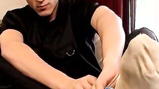 Skinny twink massages his feet and strokes massive dick
