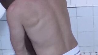 Two dudes take things to the bathroom after gym session