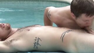 Tattoed stud blowjobs a handsome guy beside an outdoor pool