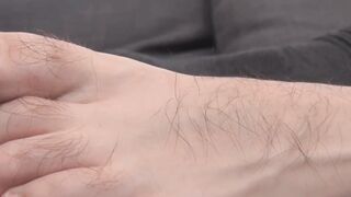 Young man jerking off with his hands and feet