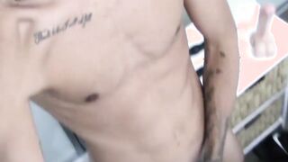 Tattooed dark skinned amateur sticks dildo on wall to play