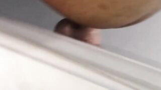 Tattooed dark skinned amateur sticks dildo on wall to play