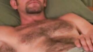 Handsome hairy dude plays with his dick and splooges solo