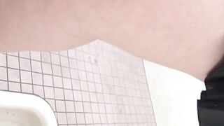 Pissing Japanese babe enjoying her time in public toilette