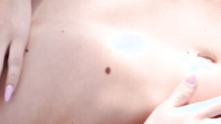 Nubile is spreading her shaved pussy while in the forest