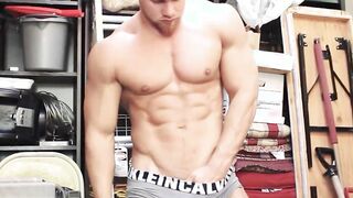 Handsome pierced hunk plays with his cock in his storage room
