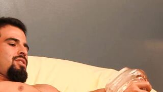Tattooed gay tickles his big balls and stroking his big cock