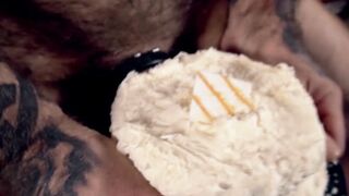 Inked hairy hunk jerks off and shoves his big cock in cake