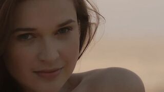 Sensual beauty is showing her naked body while on the beach