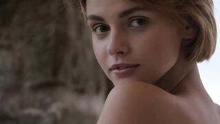 Short haired stunner presents her shaved pussy outdoors