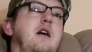 Cute amateur Jack with glasses masturbates on a leather sofa