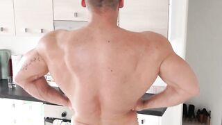 Muscular gay hunk playing with his big curved cock