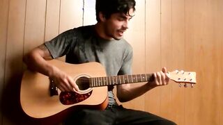 Handsome young man enjoys his guitar and jerkoff solo