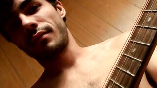 Handsome young man enjoys his guitar and jerkoff solo