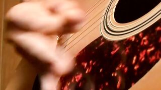 Handsome young man enjoys his guitar and jerkoff solo