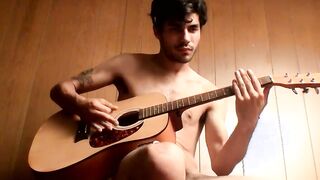 Handsome young man enjoys his guitar and jerkoff solo