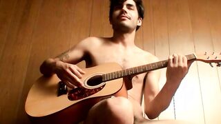 Handsome young man enjoys his guitar and jerkoff solo