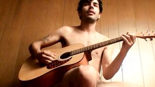 Handsome young man enjoys his guitar and jerkoff solo