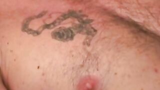 Mature and beefy gay shows off tattoo and masturbation
