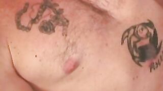 Mature and beefy gay shows off tattoo and masturbation