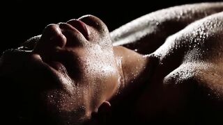 Erotic couple covered in water makes love in the dark