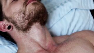 Alluring bearded gay man grabs his massive dick and wanks