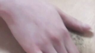 Japanese babe filmed while she fingers her hairy pussy