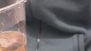 Adorable Japanese chick sits on the toilet and pees in a cup
