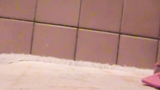 Adorable Japanese chick sits on the toilet and pees in a cup