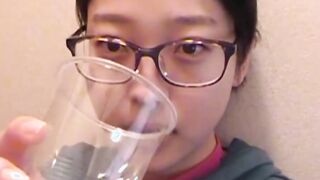 Adorable Japanese chick sits on the toilet and pees in a cup