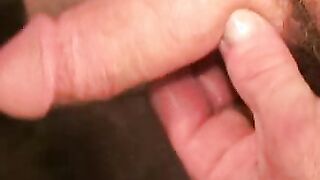 Older gay dude strokes his cock and covers himself with cum