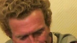 Mature dude strokes his massive cock while smoking a cigar