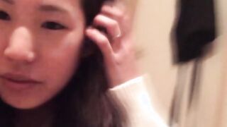 Naughty Japanese teen pees in a cup while putting makeup on